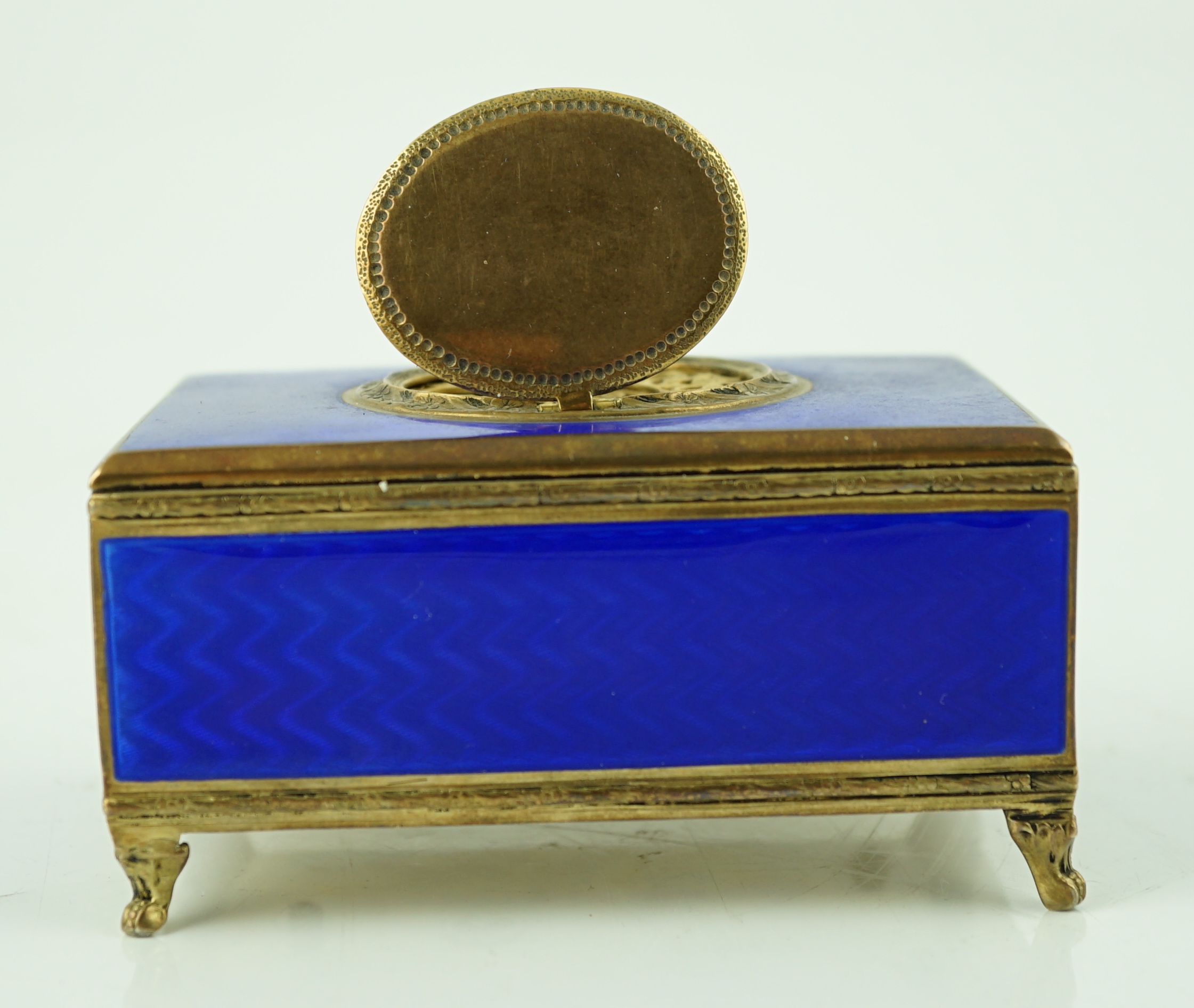 An early 20th century sterling silver gilt and blue guilloche enamelled rectangular singing bird box